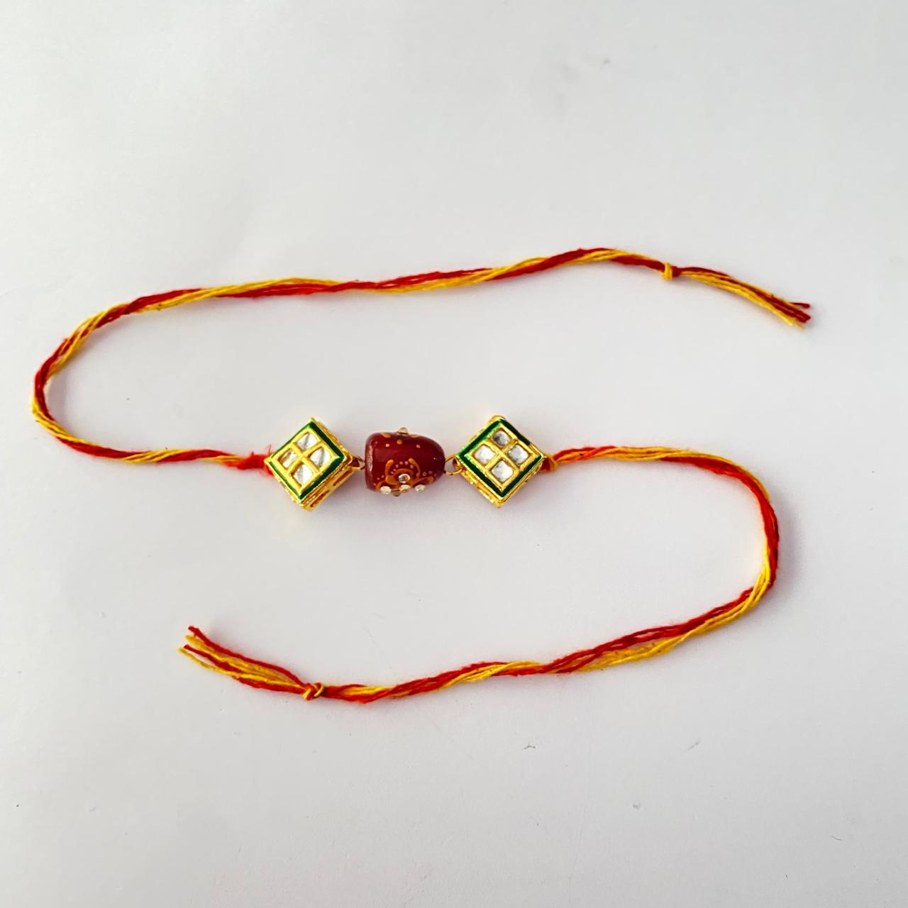 Ruby Tumbled Stone with Square Shape Gold Plated Kundan Rakhi