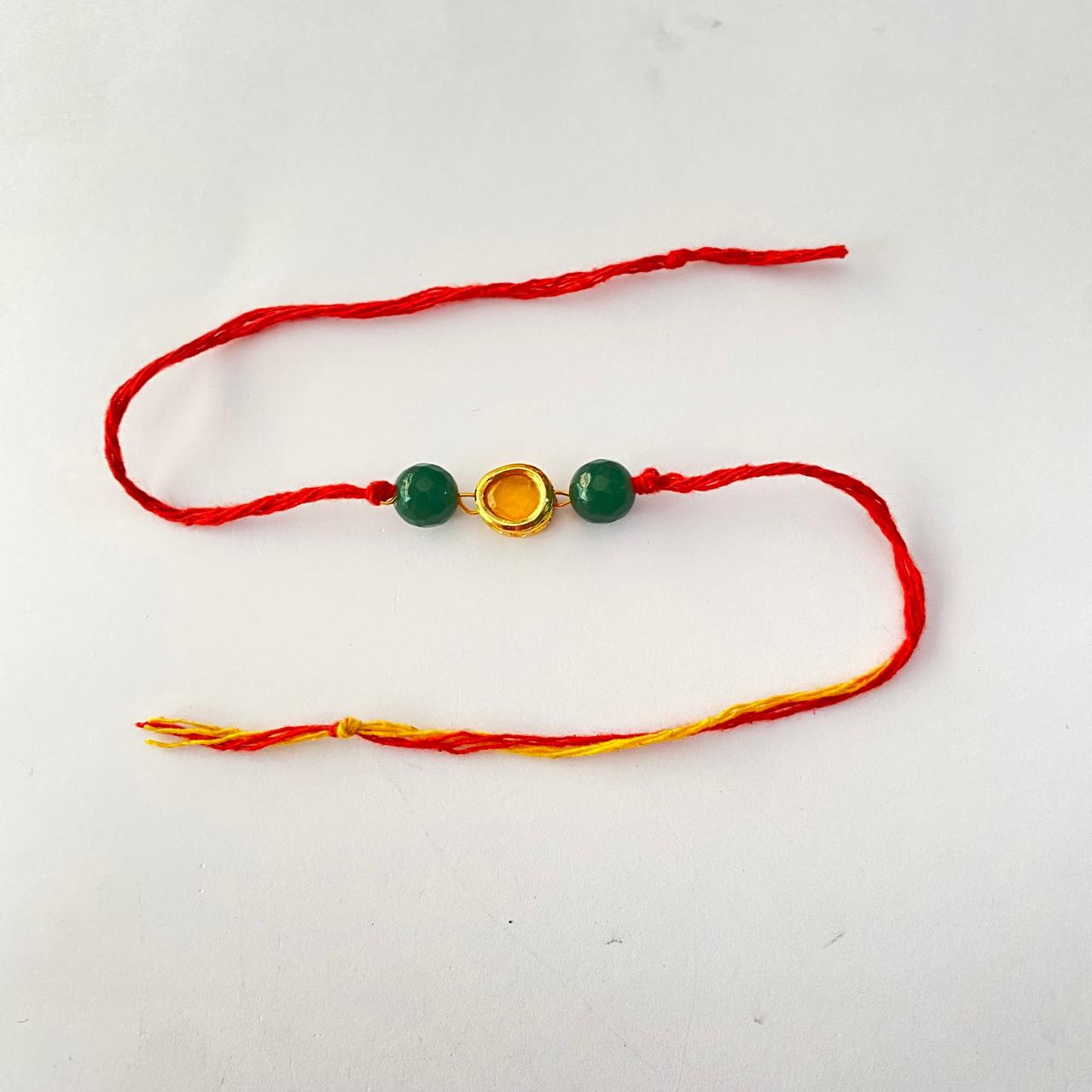 Emerald Stone with Yellow Kundan Rakhi