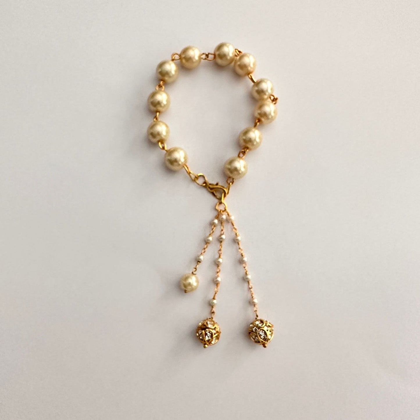 OFF-WHITE PEARL WITH GOLD PLATED CHAIN LUMBA RAKHI FOR WOMEN