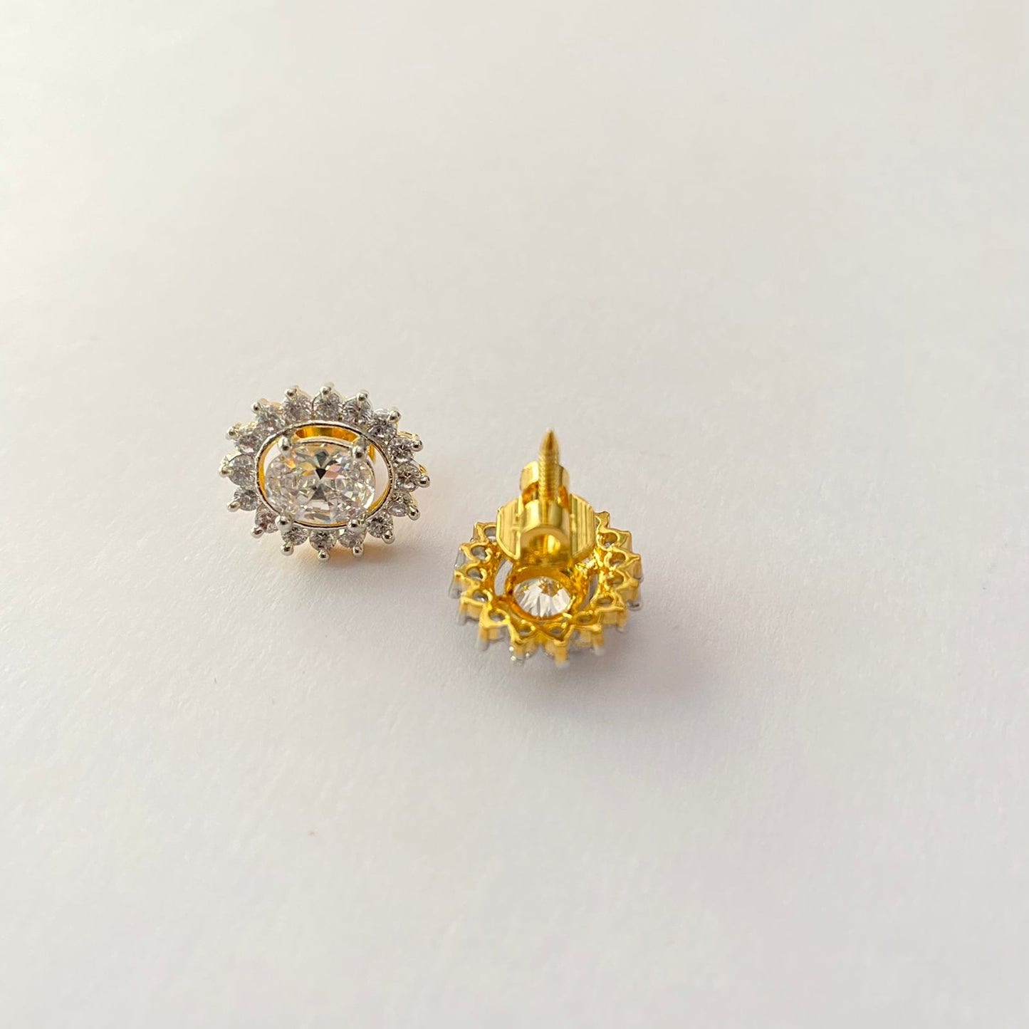 Central Oval stone surrounded by Floral Design Stones Back Screw Solitaire