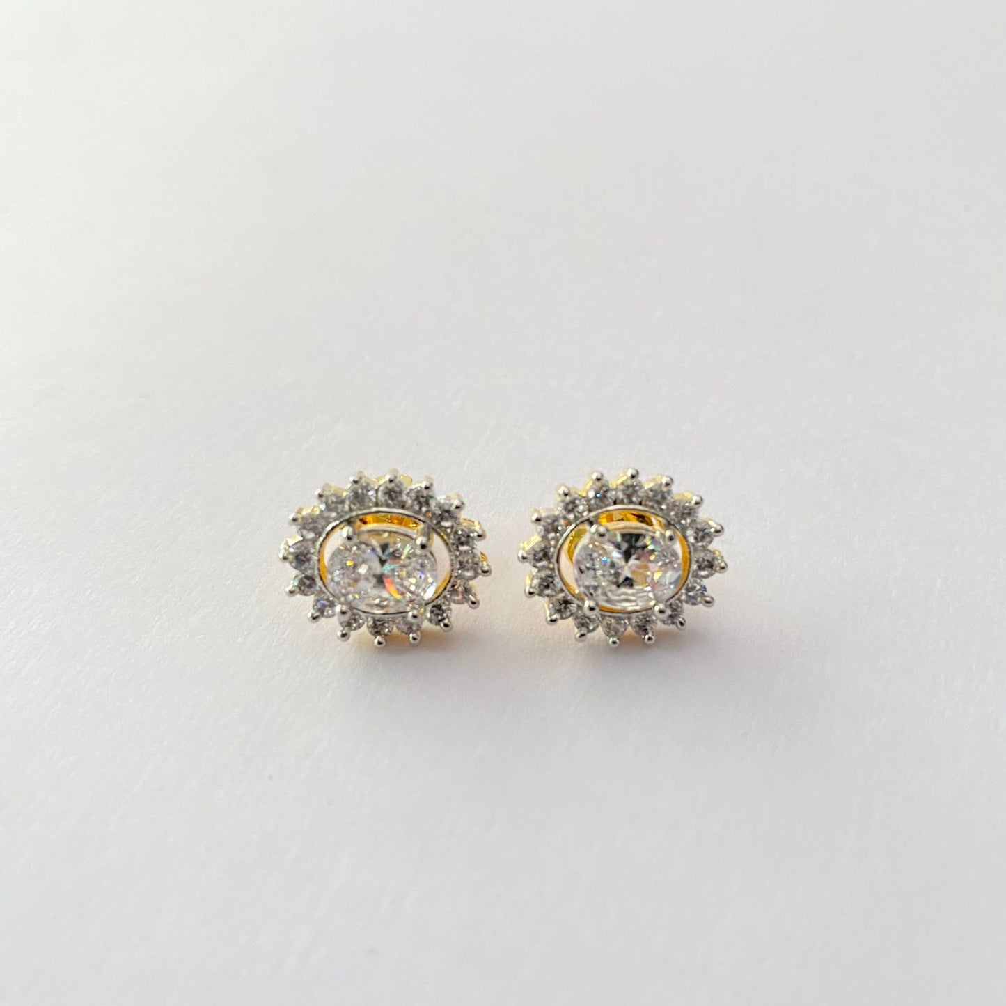 Central Oval stone surrounded by Floral Design Stones Back Screw Solitaire