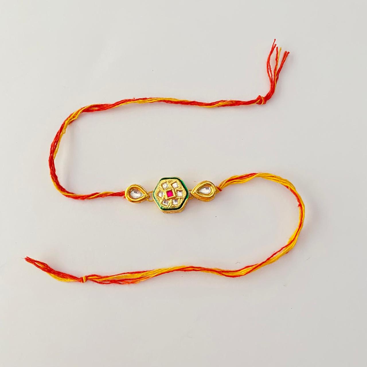 Central Hexagonal Design with a Red Stone Kundan Gold Plated Rakhi