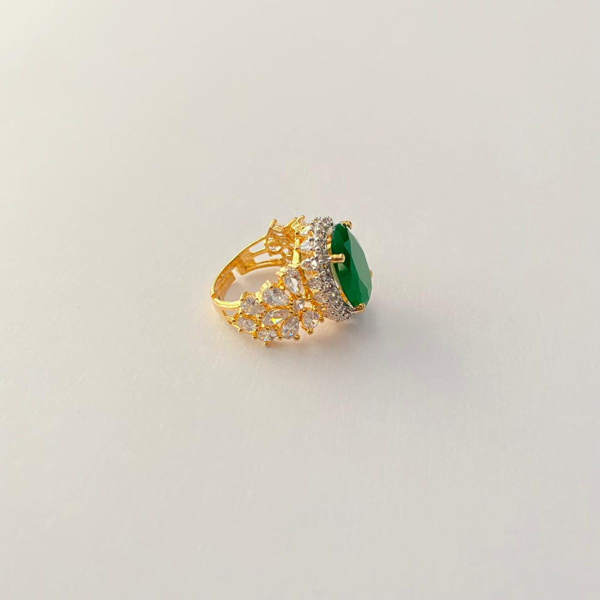 Oval Green Center Stone Surrounded by Small Diamond Gold Plated Ring